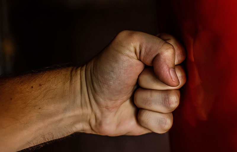 Anger Management picture showing a man hitting a wall