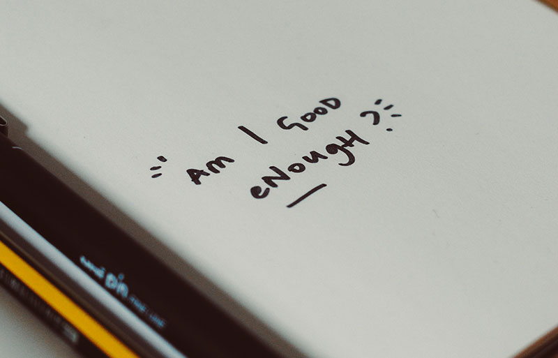 Image of a diary with the words Am I good enough written on it. Cognitive Behaviour Therapy