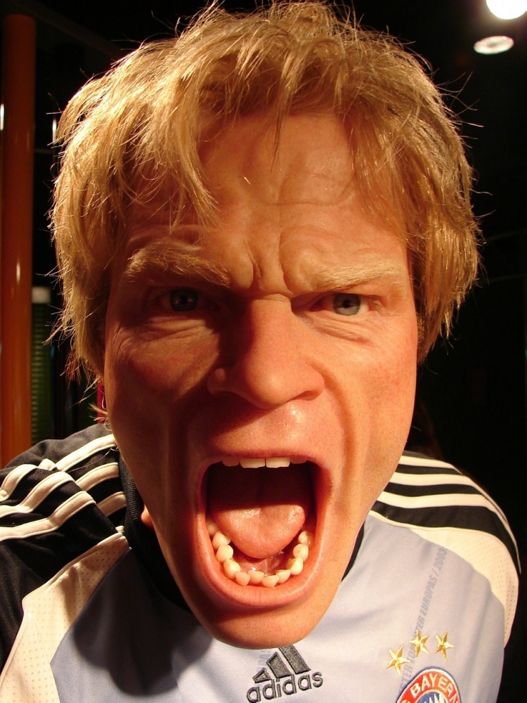 A man looking angry with his mouth wide open and frowning