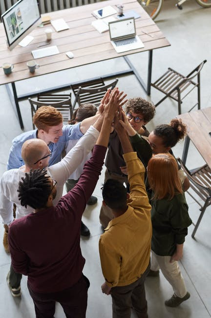 Several people holding hands up